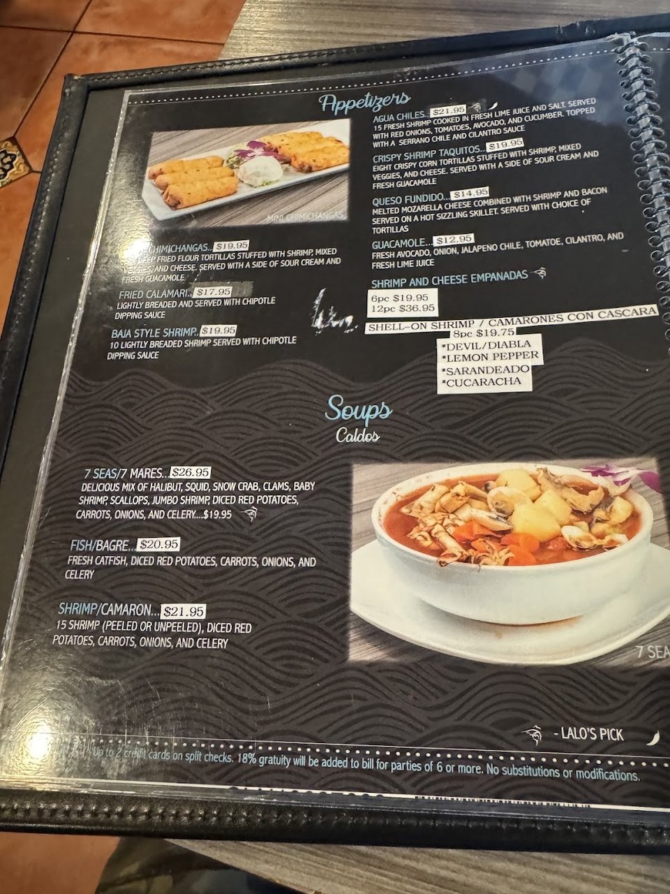 Close-up of a menu with multiple categories.